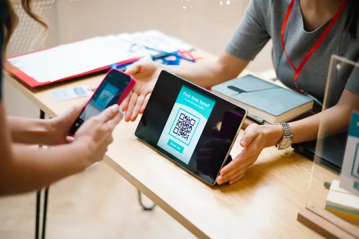 Customer scanning a QR code on a tablet