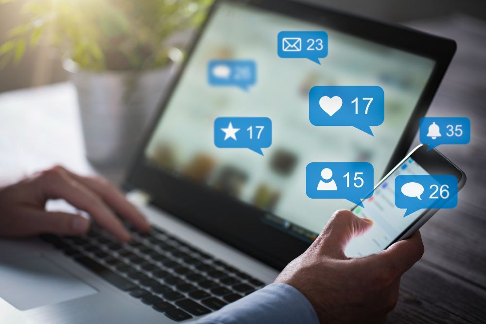Social media notifications on a laptop and phone